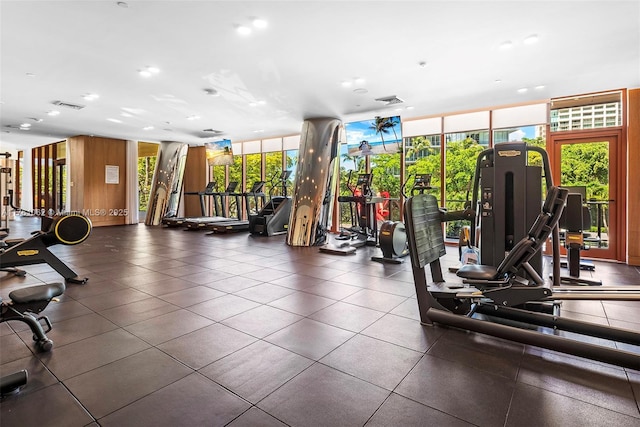 workout area featuring floor to ceiling windows and visible vents