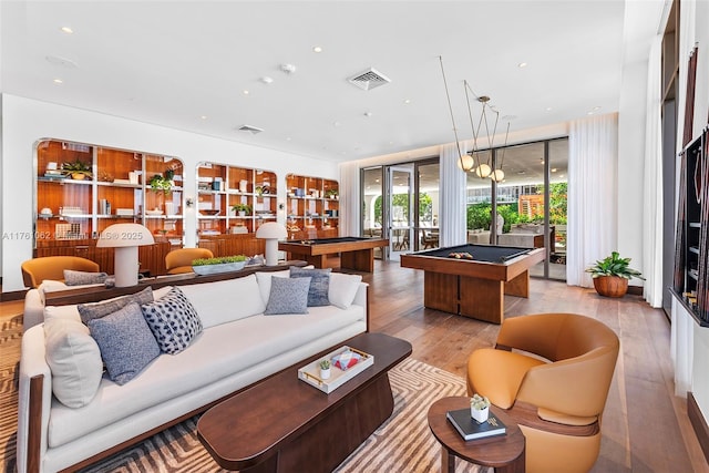 living area with visible vents, hardwood / wood-style flooring, billiards, and french doors