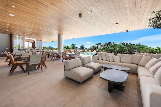 view of patio / terrace featuring outdoor dining area, an outdoor pool, and an outdoor hangout area