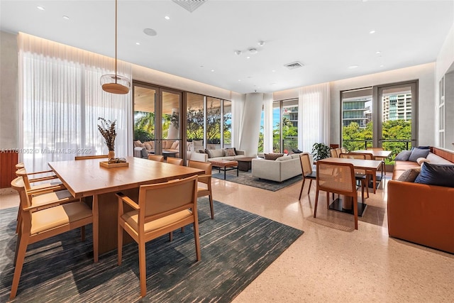 dining area featuring visible vents, recessed lighting, and speckled floor