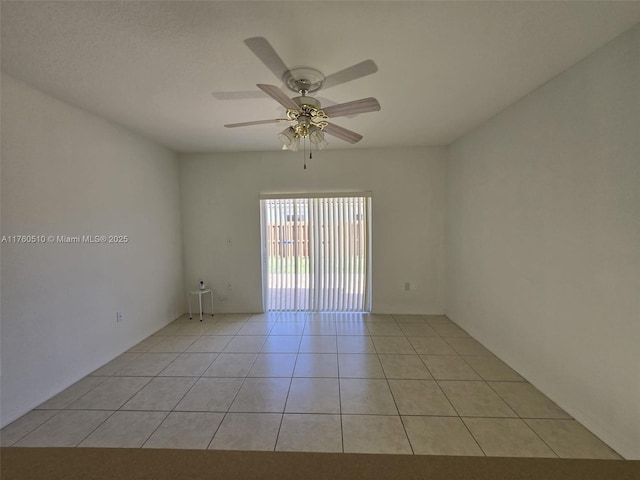 unfurnished room featuring light tile patterned flooring and a ceiling fan