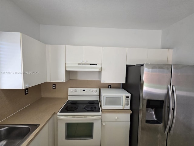 kitchen featuring white appliances, white cabinets, under cabinet range hood, and a sink