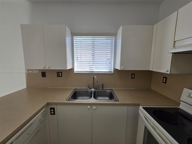 kitchen with white appliances, a sink, light countertops, under cabinet range hood, and white cabinetry