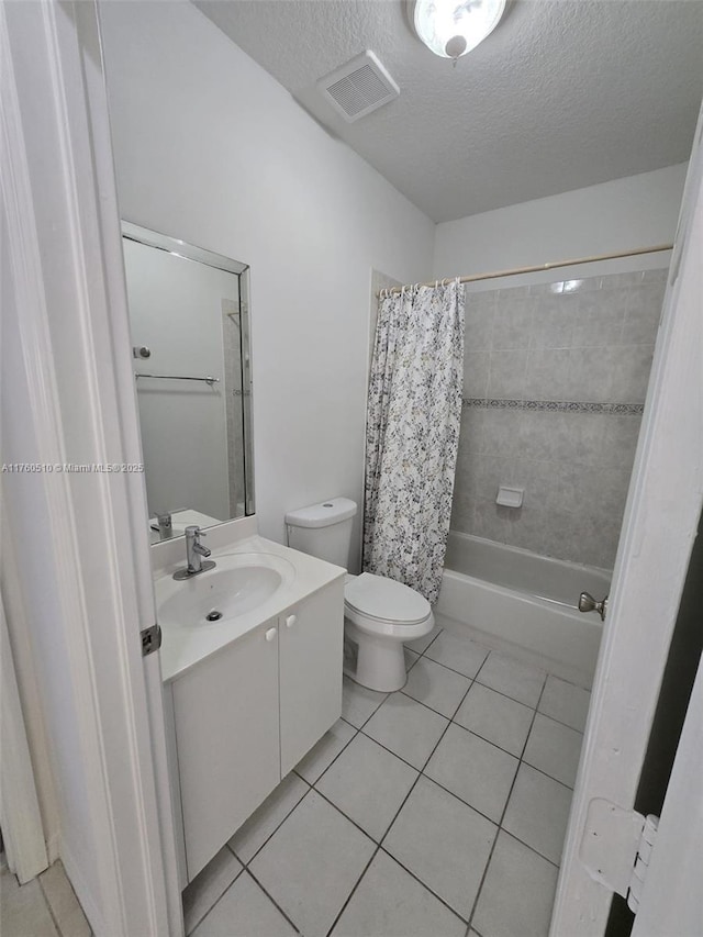 bathroom with vanity, tile patterned floors, visible vents, and a textured ceiling