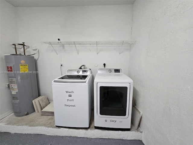 laundry area with electric water heater, laundry area, and washing machine and clothes dryer