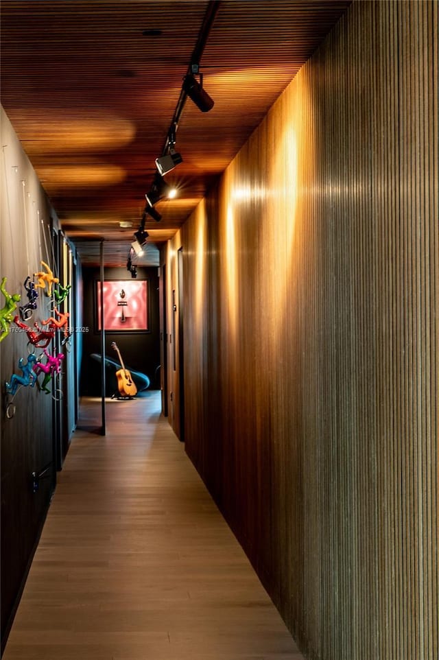 hall featuring light wood-style flooring and wooden ceiling