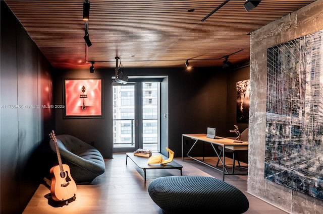 interior space with track lighting, wood finished floors, and wooden ceiling