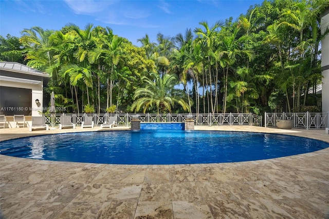 view of swimming pool with a patio, fence, and a fenced in pool