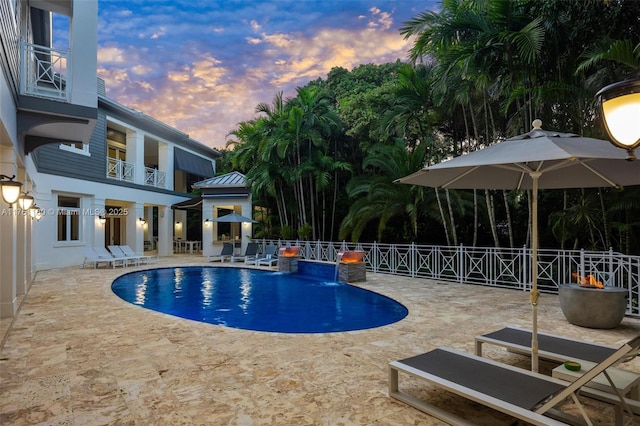 view of swimming pool featuring a fenced in pool, fence, and a patio area