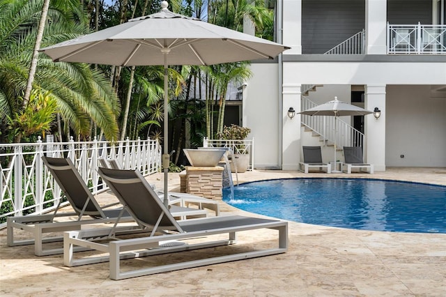 view of swimming pool with a fenced in pool and a patio area