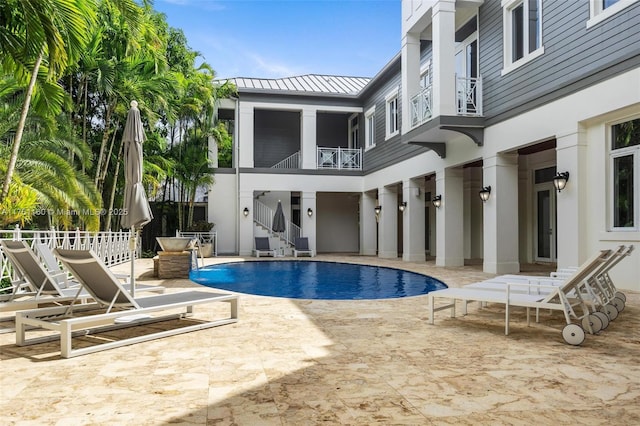 view of pool with a patio, stairway, a fenced in pool, and fence