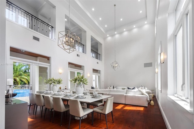 dining room featuring plenty of natural light, wood finished floors, and a chandelier