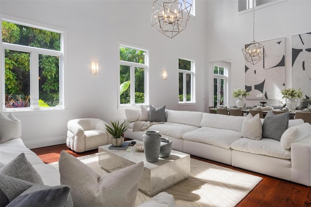 living room with a notable chandelier, wood finished floors, and plenty of natural light