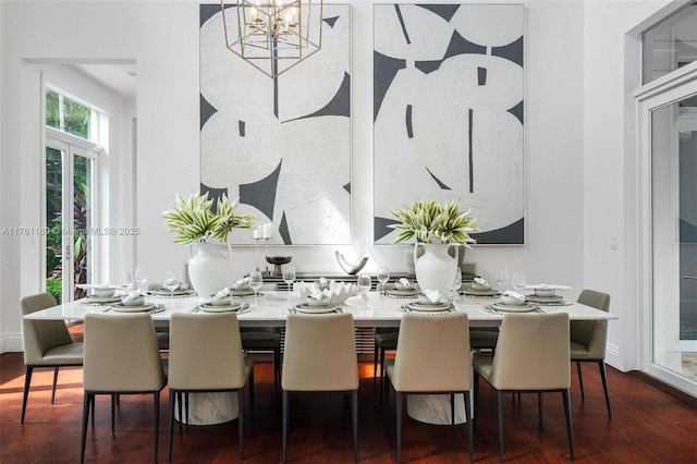 dining room with baseboards, an inviting chandelier, and dark wood finished floors