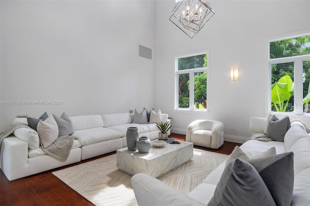 living room featuring a wealth of natural light, visible vents, baseboards, and dark wood-type flooring