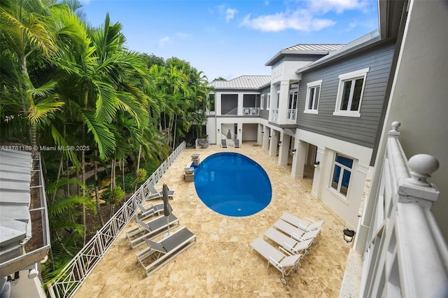 pool with a patio area, stairs, and a fenced backyard