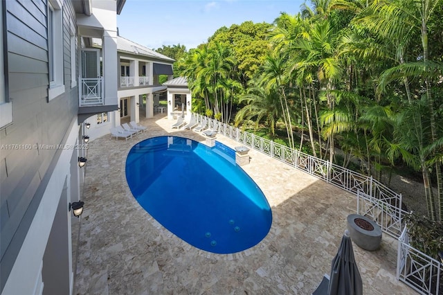 view of pool featuring a patio area, a fenced in pool, and fence