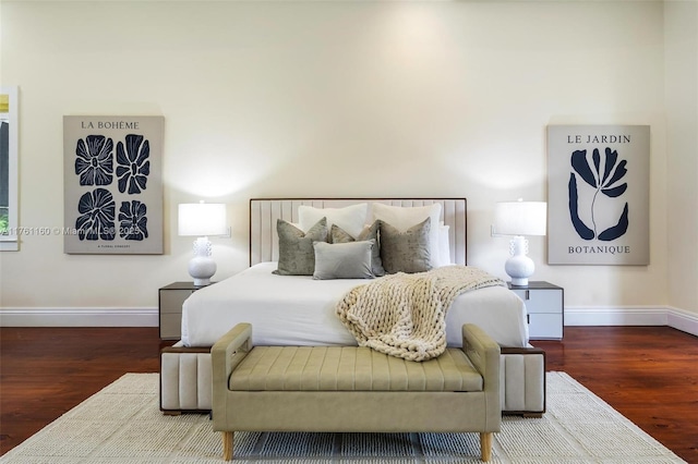 bedroom with wood finished floors and baseboards