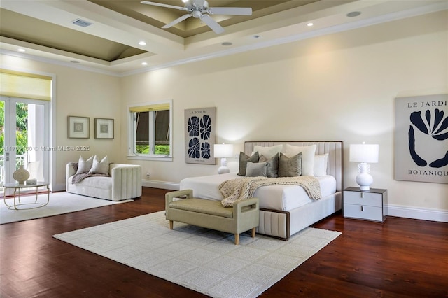 bedroom featuring wood finished floors, baseboards, a tray ceiling, a high ceiling, and recessed lighting