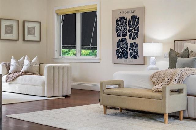 bedroom featuring baseboards and wood finished floors