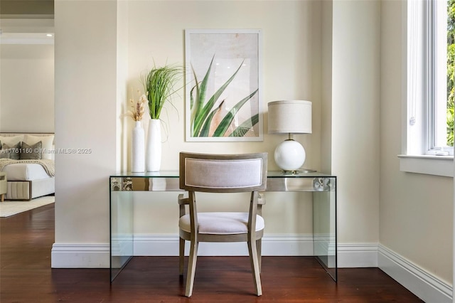 dining area featuring baseboards and wood finished floors