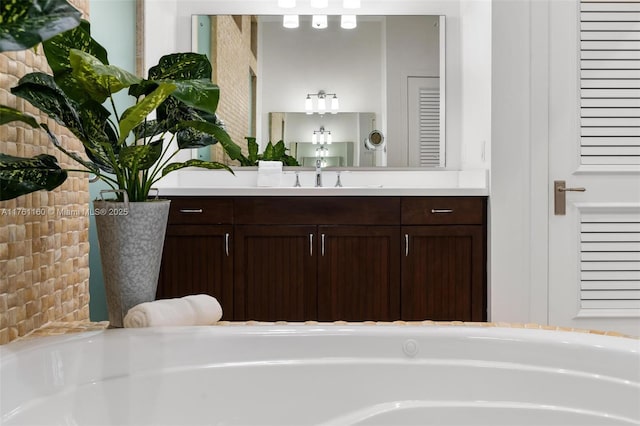 full bath featuring a garden tub and vanity