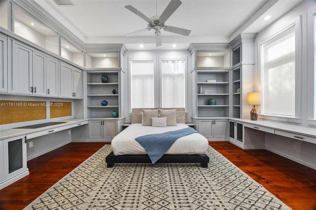 bedroom with dark wood finished floors, recessed lighting, and built in study area