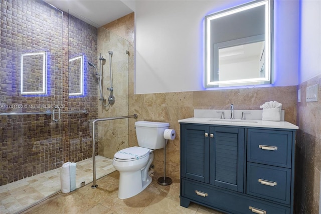 full bath with tiled shower, toilet, tile walls, and vanity