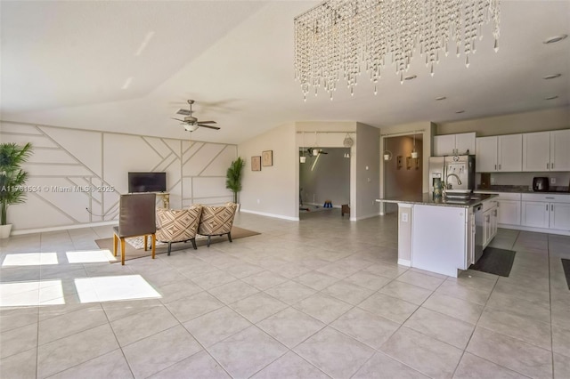 kitchen featuring open floor plan, stainless steel appliances, light tile patterned floors, ceiling fan, and vaulted ceiling