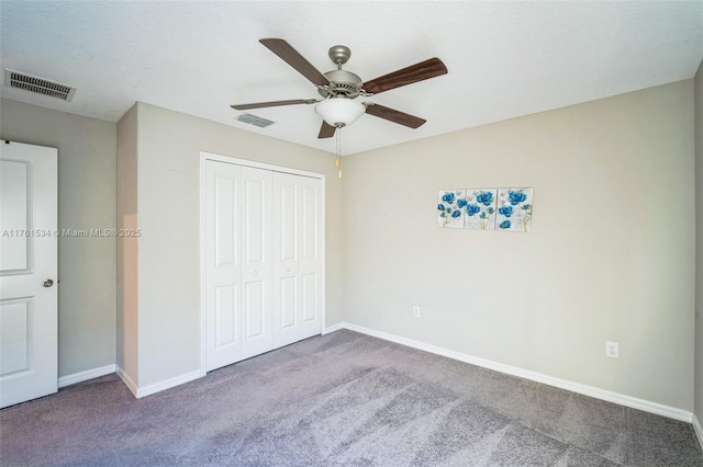 unfurnished bedroom featuring a closet, visible vents, and carpet floors