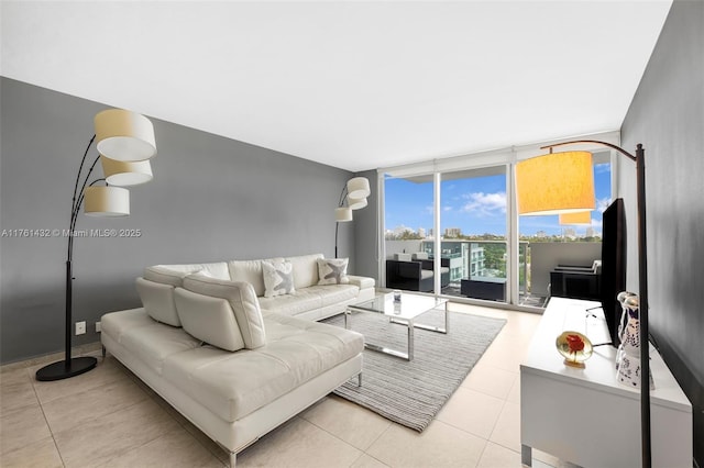 living room with light tile patterned floors and floor to ceiling windows