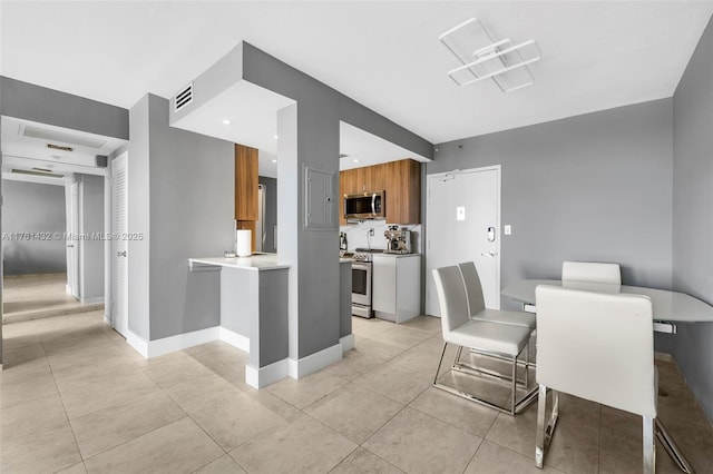 dining area featuring visible vents, baseboards, and light tile patterned flooring