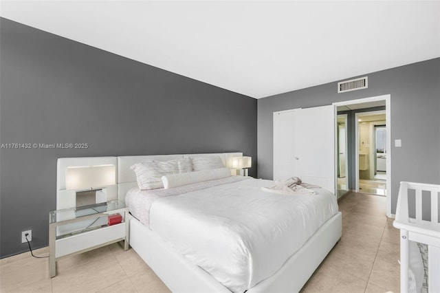 bedroom with light tile patterned floors, baseboards, and visible vents