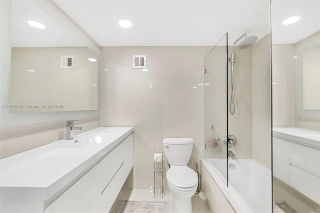 bathroom with visible vents, toilet, vanity, and  shower combination