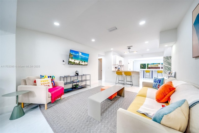 living area featuring recessed lighting and visible vents