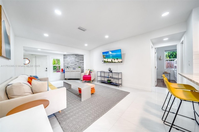 living room with recessed lighting, visible vents, and baseboards