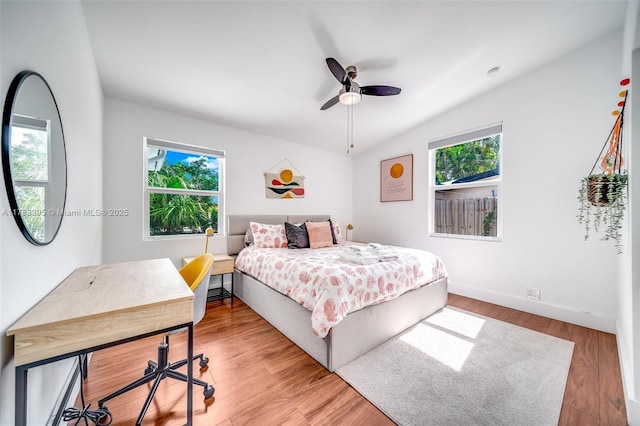 bedroom featuring ceiling fan, baseboards, and wood finished floors