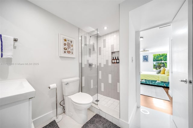 bathroom with toilet, connected bathroom, a shower stall, baseboards, and vanity