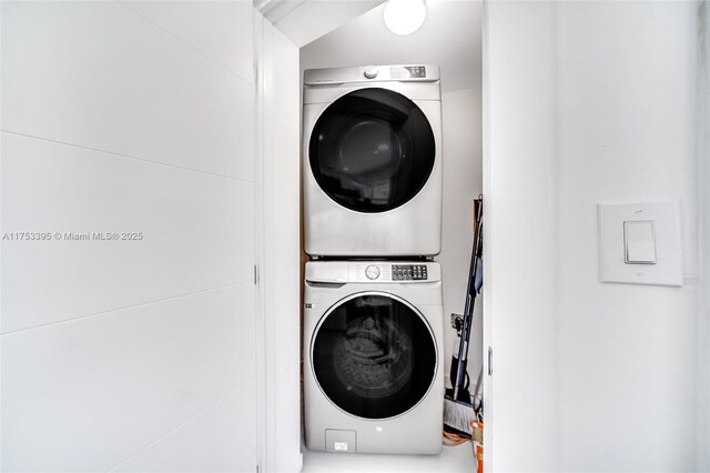 laundry room with stacked washer / drying machine and laundry area