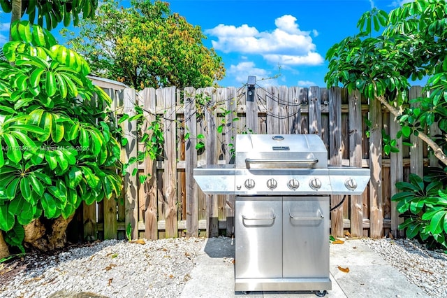 view of patio / terrace with a grill and fence