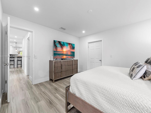 bedroom featuring light wood-type flooring, visible vents, baseboards, and recessed lighting