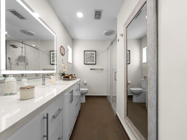 full bathroom with vanity, a shower stall, toilet, and visible vents