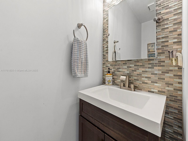 bathroom with decorative backsplash and vanity