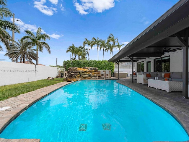 view of pool with an outdoor living space, a patio, a fenced backyard, a fenced in pool, and ceiling fan