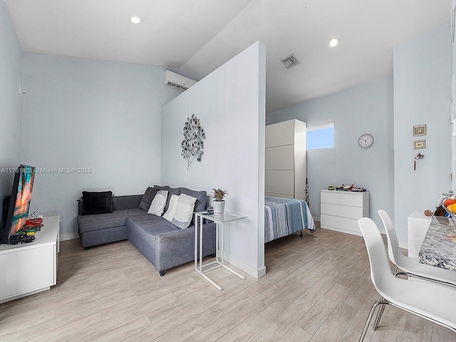 bedroom featuring baseboards, visible vents, recessed lighting, an AC wall unit, and light wood-type flooring