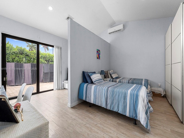 bedroom featuring access to exterior, baseboards, a wall mounted air conditioner, vaulted ceiling, and light wood-style floors