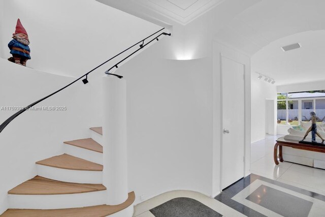 stairs featuring tile patterned flooring