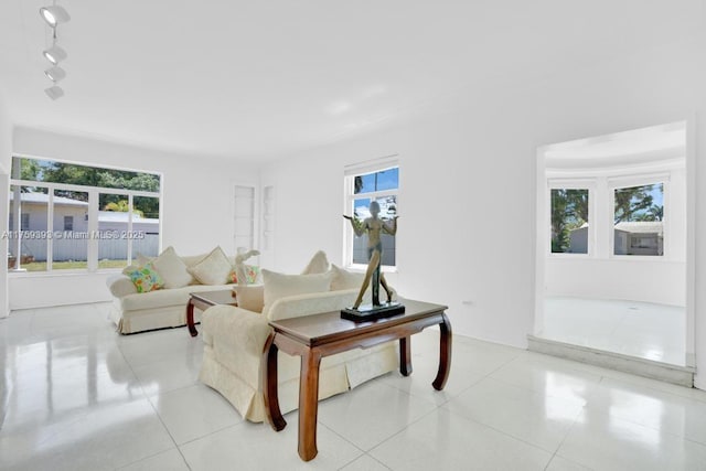 living area featuring plenty of natural light, light tile patterned floors, and track lighting
