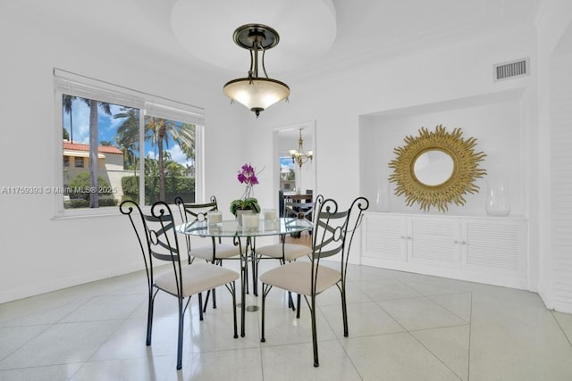 dining area featuring a chandelier, visible vents, baseboards, and light tile patterned flooring