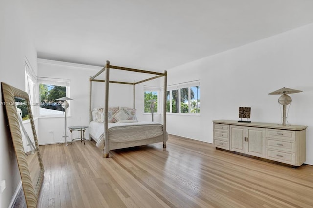 bedroom featuring light wood-style floors and multiple windows